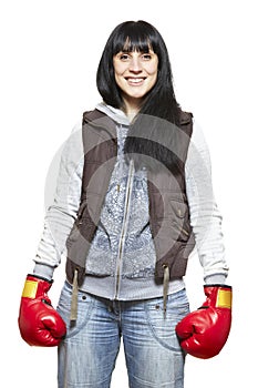 Young woman wearing boxing gloves smiling