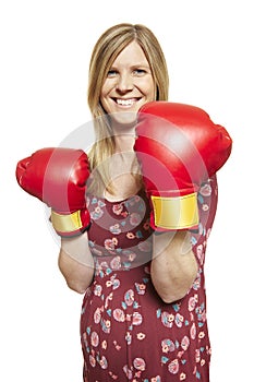 Young woman wearing boxing gloves smiling