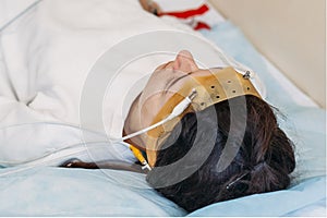 Young woman wearing the brainwave Scanning Headset Sits in a Chair In the Brain Study Laboratory Neurological Research Center