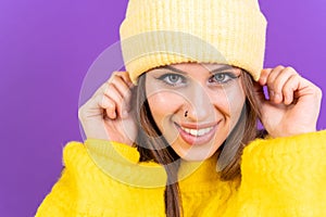 Young woman wearing a bright yellow coat and a coordinating yellow hat