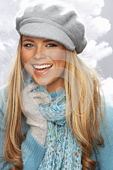 Young Woman Wearing Cap And Knitwear In Studio