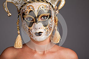 Young woman wearing carnival mask