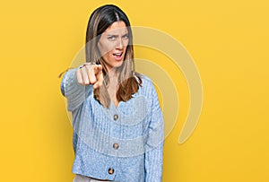 Young woman wearing casual clothes pointing displeased and frustrated to the camera, angry and furious with you