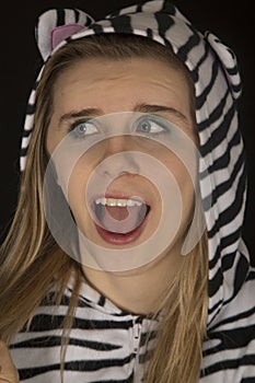 Young woman wearing cat pajamas surprised facial expression