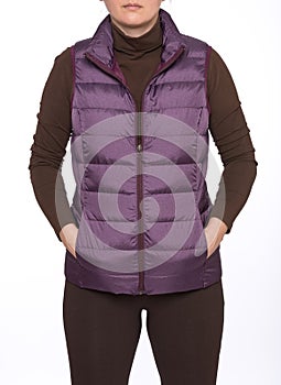 Young woman wearing dark plum down vest