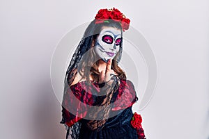 Young woman wearing day of the dead costume over white beckoning come here gesture with hand inviting welcoming happy and smiling