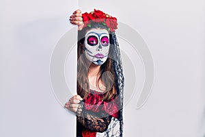 Young woman wearing day of the dead custome holding blank empty banner depressed and worry for distress, crying angry and afraid