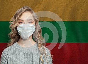 Young woman wearing a face mask with Lithuanian  flag. Flu epidemic and virus protection concept