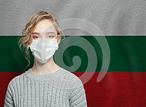 Young woman wearing a face mask with national flag Bulgaria.  Flu epidemic and virus protection concept