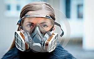 Young woman wearing full face respirator protective mask and goggles, extreme coronavirus protection concept