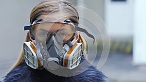 Young woman wearing full face respirator protective mask and goggles, extreme coronavirus protection concept