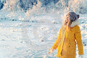 Young Woman wearing gloves playing with snow outdoor Winter vacations