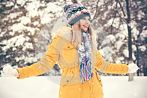 Young Woman wearing hat and scarf happy smiling playing outdoor
