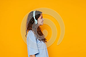 Young woman wearing headphones smiling and listening to music