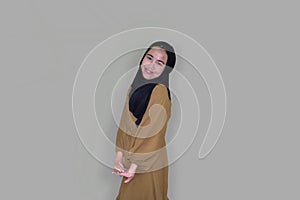 Young woman wearing hijab poses coquettishly and excitedly