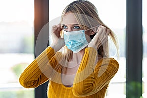 Young woman wearing an hygienic mask to prevent others from a virus in the office