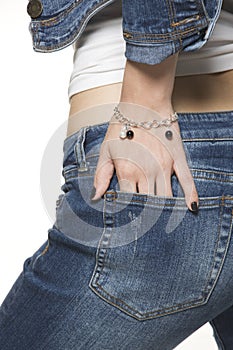 Young woman wearing jeans and silver bracelet