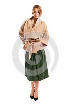 Young woman wearing light colour coat and green skirt