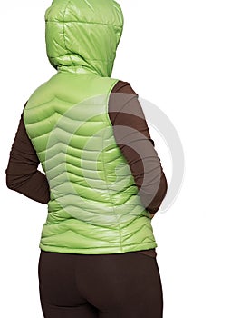 Young woman wearing light green hooded packable down puffer vest photo