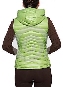 Young woman wearing light green hooded packable down puffer vest photo