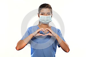 Young Woman Wearing Medical Scrubs and a Surgical Mask photo