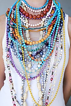 Young woman wearing multi coloured beads and necklaces