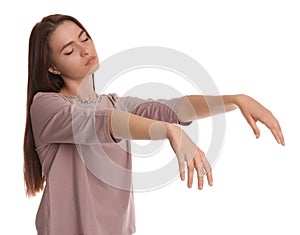 Young woman wearing pajamas in sleepwalking state on white background photo
