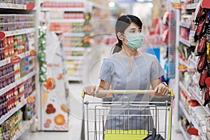 Young woman wearing protective face mask and  shopping in grocery or department store protect coronavirus inflection. social