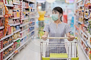 Young woman wearing protective face mask and  shopping in grocery or department store protect coronavirus inflection. social