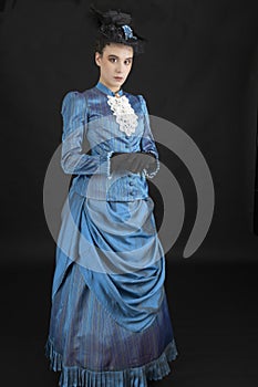 A young woman wearing an 1880s Victorian costume