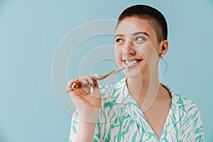 Young woman wearing shirt smiling and eating candy gummy