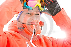 Young woman wearing ski goggles outdoors