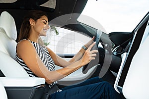 Young woman wearing stylish blouse feeling good while driving