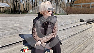 Young woman wearing stylish sunglasses near river