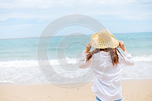 Young woman wearing sun hat on the  beach. summer, holidays, vacation, travel concept