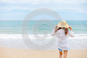 Young woman wearing sun hat on the  beach. summer, holidays, vacation, travel concept