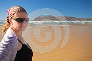 Young woman wearing sunglasses on the beach at Muizenberg