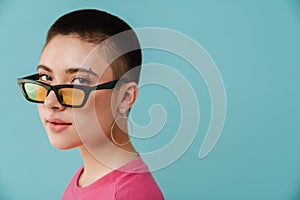 Young woman wearing sunglasses posing and looking at camera