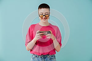 Young woman wearing sunglasses smiling and using cellphone