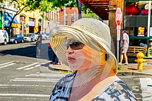 Young woman wearing sunglasses and sun hat