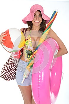 Young Woman Wearing a Swim Suit on Holiday Carrying Beach Items