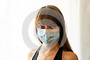 Young woman wearing teal surgical face mask