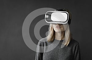 Young woman wearing virtual reality goggles headset, vr box. Connection, technology, new generation, progress concept