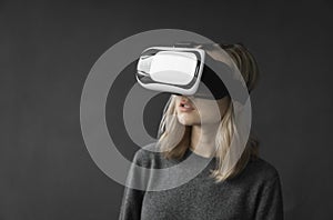 Young woman wearing virtual reality goggles headset, vr box. Connection, technology, new generation, progress concept