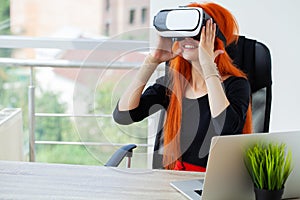 Young woman wearing virtual reality goggles in modern coworking studio.