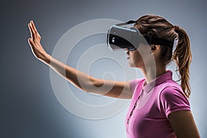 Young woman wearing virtual reality headset in studio. Emotions. Side view