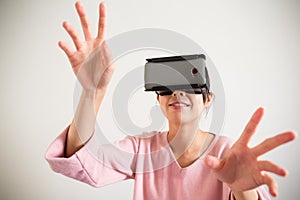 Young Woman wearing vr device and hand want to touch somrth