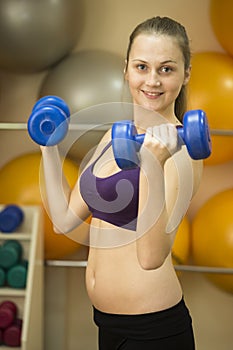 Young woman weight workout with dumbbells