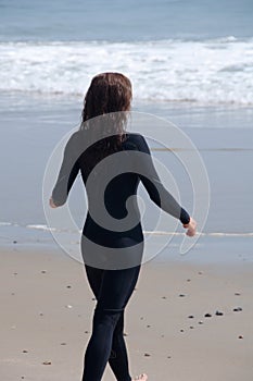 Young Woman in a Wetsuit at Beach