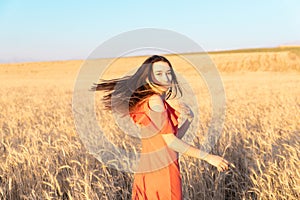 Young woman in the wheat field. Look back. Finding inner balance concept. Copy space.